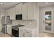 Modern kitchen with white cabinets, quartz countertops, and stainless steel appliances at 11482 Boundless Ter, Venice, FL 34293