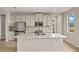Modern kitchen with white cabinets, quartz countertops, and stainless steel appliances at 11482 Boundless Ter, Venice, FL 34293