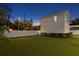 Well-manicured backyard with a green lawn enclosed by a white fence at 120 25Th N Ave, St Petersburg, FL 33704