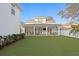 Expansive backyard featuring a covered patio, manicured lawn, and outdoor seating areas for entertaining at 120 25Th N Ave, St Petersburg, FL 33704