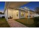 Charming backyard featuring a covered patio, putting green and brick pathway to outdoor relaxation at 120 25Th N Ave, St Petersburg, FL 33704