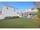 Large manicured backyard with a covered patio and outdoor seating, perfect for relaxation and entertaining at 120 25Th N Ave, St Petersburg, FL 33704