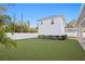 Beautifully landscaped backyard with white fence, manicured lawn and detached garage space at 120 25Th N Ave, St Petersburg, FL 33704
