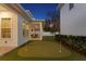 Backyard with putting green, covered patio, and lush landscaping for outdoor enjoyment at 120 25Th N Ave, St Petersburg, FL 33704