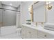 Bathroom featuring a bathtub, gray tile, and a white vanity with gold hardware at 120 25Th N Ave, St Petersburg, FL 33704