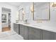 Bright bathroom featuring white marble floors, gray vanity, and gold fixtures at 120 25Th N Ave, St Petersburg, FL 33704