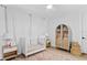 Bright Bedroom with a white crib, stylish rug, and elegant decor creates a comforting and inviting space at 120 25Th N Ave, St Petersburg, FL 33704