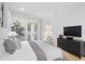 Bright bedroom features a luxurious bed, TV, and access to the outdoors at 120 25Th N Ave, St Petersburg, FL 33704
