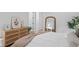Bedroom with a wood dresser, white bedding, and a view into the bathroom at 120 25Th N Ave, St Petersburg, FL 33704