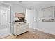 Bright bedroom featuring an elegant dresser with decorative accents and an adjacent bathroom with a tub at 120 25Th N Ave, St Petersburg, FL 33704
