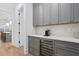 Butler's pantry with gray cabinetry, wine fridge, quartz countertop and stylish hardware at 120 25Th N Ave, St Petersburg, FL 33704