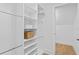 Walk-in closet featuring custom storage, shelving, and hardwood floors at 120 25Th N Ave, St Petersburg, FL 33704