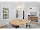Elegant dining room featuring a modern chandelier, wainscoting, and plantation shutters at 120 25Th N Ave, St Petersburg, FL 33704
