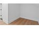 A clean, empty room with fresh white paint, updated baseboards, and hardwood floors at 120 25Th N Ave, St Petersburg, FL 33704