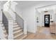 Bright foyer featuring hardwood floors, staircase with black metal railings, and transom windows at 120 25Th N Ave, St Petersburg, FL 33704