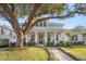 Inviting home exterior with lush landscaping, a curved brick pathway and charming front porch at 120 25Th N Ave, St Petersburg, FL 33704