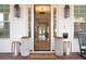 Inviting front porch with decorative planters and stylish lanterns flanking the doorway at 120 25Th N Ave, St Petersburg, FL 33704