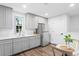 This kitchen features stainless steel appliances, gray cabinets, and hardwood floors at 120 25Th N Ave, St Petersburg, FL 33704
