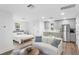 Well-lit living area with a seating arrangement, a small kitchen, and a comfortable bedroom space at 120 25Th N Ave, St Petersburg, FL 33704