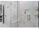 New tiled shower with glass doors, a built-in bench, and gold hardware at 120 25Th N Ave, St Petersburg, FL 33704