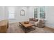 Bright sitting room with a comfortable chair, patterned rug, and large bright windows at 120 25Th N Ave, St Petersburg, FL 33704