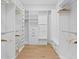 Spacious walk-in closet with custom shelving, drawers, and a bench at 120 25Th N Ave, St Petersburg, FL 33704