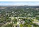 Aerial view showcasing the property's setting within a tree-lined neighborhood and city skyline at 1214 E Curtis St, Tampa, FL 33603