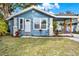 Charming blue house with white trim and well-maintained lawn at 1214 E Curtis St, Tampa, FL 33603