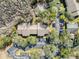 Aerial view of building, parking lot, and surrounding trees at 12218 Fox Chase Dr # G2, Hudson, FL 34669
