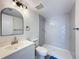 Modern bathroom with gray tile shower and white vanity at 12218 Fox Chase Dr # G2, Hudson, FL 34669