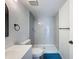Updated bathroom with gray tile shower and white vanity at 12218 Fox Chase Dr # G2, Hudson, FL 34669