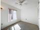 Bright bedroom featuring carpet flooring and a ceiling fan at 12218 Fox Chase Dr # G2, Hudson, FL 34669