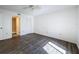 Bedroom with wood-look floors, ceiling fan, and en-suite bath at 12218 Fox Chase Dr # G2, Hudson, FL 34669