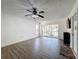 Living room with wood-look floors and sliding doors at 12218 Fox Chase Dr # G2, Hudson, FL 34669