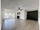 Living Room with wood-look floors and sliding doors at 12218 Fox Chase Dr # G2, Hudson, FL 34669