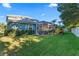 Spacious backyard with lush landscaping and screened patio at 12833 Darby Ridge Dr, Tampa, FL 33624