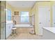 Bathroom with a large bathtub, a walk-in shower, and beige tile at 12833 Darby Ridge Dr, Tampa, FL 33624