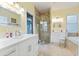 Bathroom with white cabinets, a large shower, and a soaking tub at 12833 Darby Ridge Dr, Tampa, FL 33624