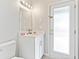 Simple bathroom with white vanity and a door to the outdoors at 12833 Darby Ridge Dr, Tampa, FL 33624