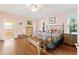 Spacious bedroom with hardwood floors, a large bed, and built-in wooden cabinets at 12833 Darby Ridge Dr, Tampa, FL 33624