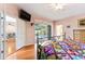 Main bedroom with a king-size bed, hardwood floors, and sliding doors to the pool at 12833 Darby Ridge Dr, Tampa, FL 33624