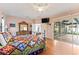 Main bedroom with a king-size bed, hardwood floors, and sliding doors to the pool at 12833 Darby Ridge Dr, Tampa, FL 33624