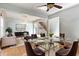Bright dining room with a glass table and chairs, adjacent to the living room at 12833 Darby Ridge Dr, Tampa, FL 33624