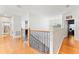 Upper hallway with hardwood floors and a view of a bedroom and bathroom at 12833 Darby Ridge Dr, Tampa, FL 33624