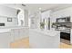 Modern kitchen with white cabinets, stainless steel appliances, and a large island at 12833 Darby Ridge Dr, Tampa, FL 33624