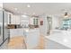 Bright kitchen with white cabinets, stainless steel appliances, and a large island at 12833 Darby Ridge Dr, Tampa, FL 33624
