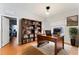 Home office with hardwood floors, a large desk, and built-in bookshelves at 12833 Darby Ridge Dr, Tampa, FL 33624