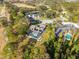 Aerial shot of a property featuring a luxurious pool area with a screened enclosure, surrounded by green trees at 13032 Whisper Sound Dr, Tampa, FL 33618