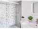 Bathroom with patterned tile shower and white vanity at 1398 Shady Pine Way # E3, Tarpon Springs, FL 34688