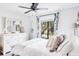 Bedroom with white bedding and coastal decor at 1398 Shady Pine Way # E3, Tarpon Springs, FL 34688